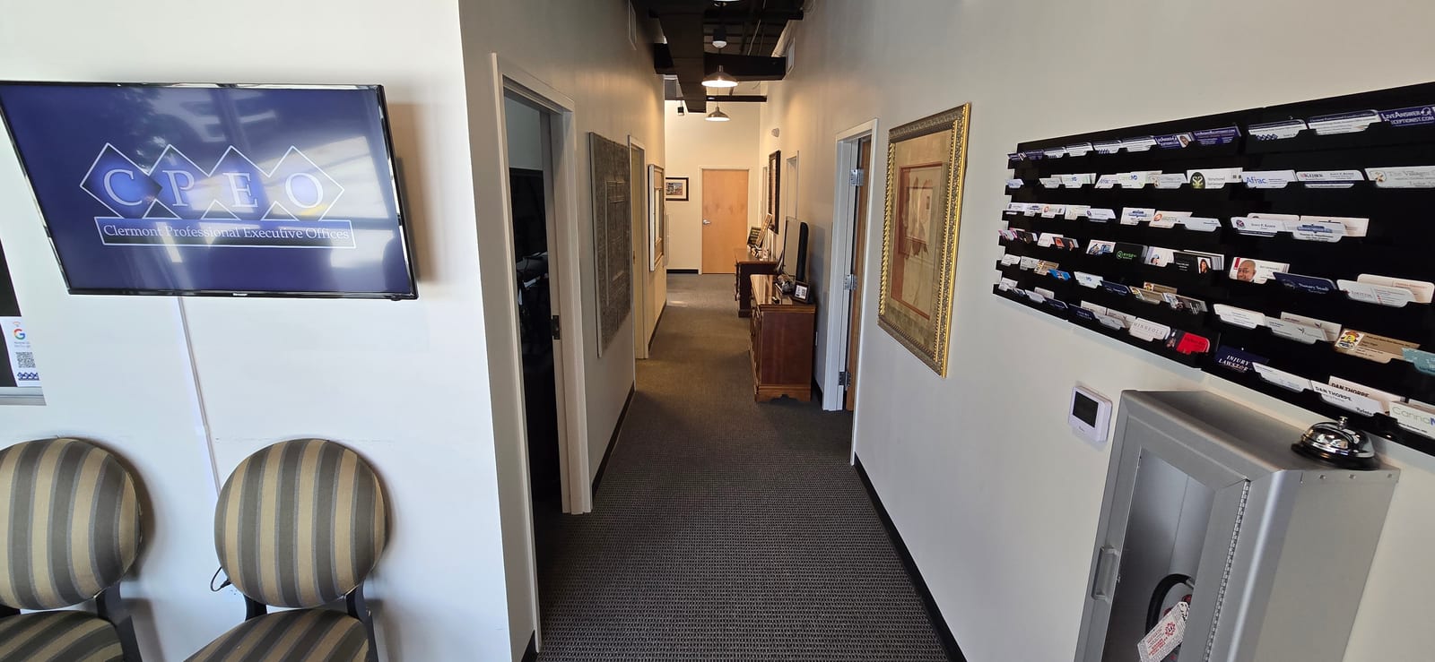 CPEO hallway with business card display and tenant directory screen